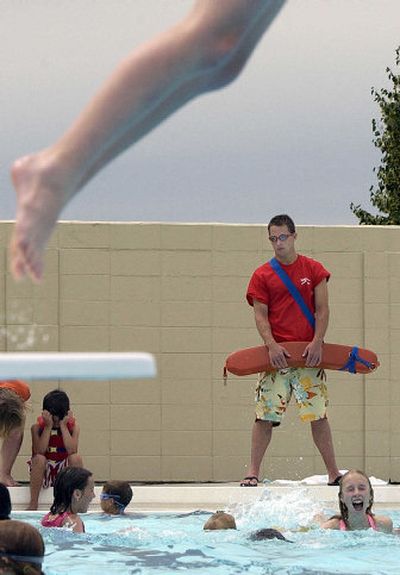 
Chris Lyden keeps watch while kids play at Valley Mission Pool. Lyden has been a lifeguard for two years. 
 (Liz Kishimoto / The Spokesman-Review)