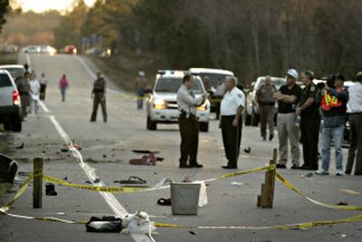
Investigators work at the scene of a crash where seven children in a car were killed Wednesday near Lake Butler, Fla. 
 (Associated Press / The Spokesman-Review)