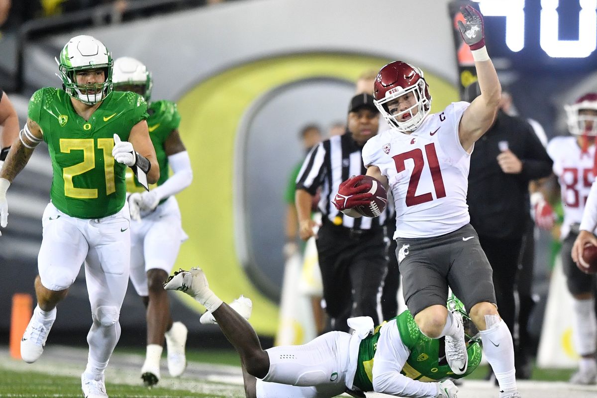 Washington State running back Max Borghi, who finished with 41 yards on 10 carries, maneuvers against Oregon for a first down during the first half Saturday in Eugene.  (Tyler Tjomsland/The Spokesman-Review)