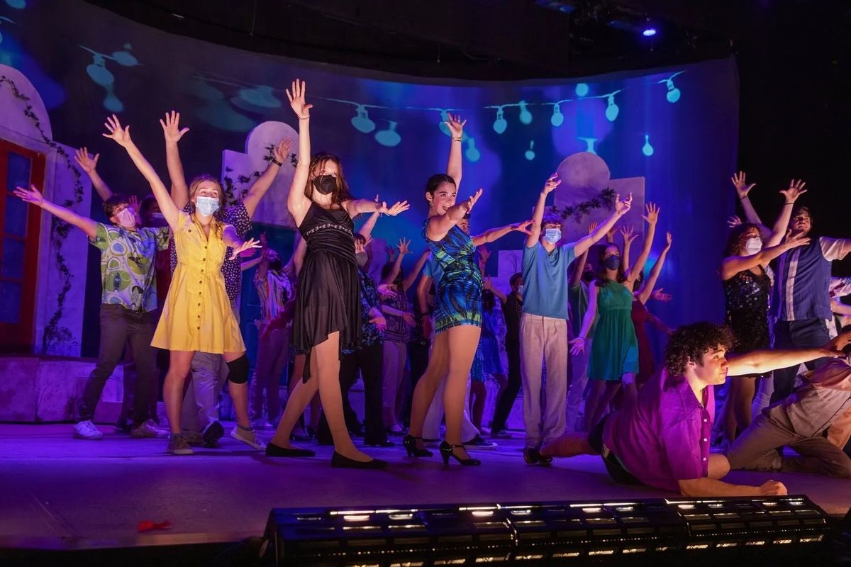 Roosevelt High School students perform at the dress rehearsal for “Mamma Mia!” on Monday. This year’s cast features 10 members of the school’s football team.  (Ken Lambert/Seattle Times)