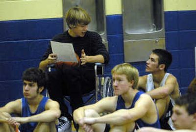 
Valley Christian leading scores Jamie Bennett (in wheelchair) talks with Jeff Pope about the Panthers statistics while coach Allen talked to the team Monday. Bennett is out indefinately with a foot injury.
 (J. BART RAYNIAK / The Spokesman-Review)