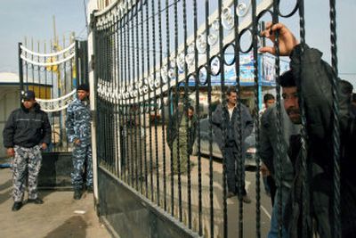
A Palestinian man, right, looks through the closed gate of the Rafah border crossing between the Gaza Strip and Egypt Friday. 
 (Associated Press / The Spokesman-Review)
