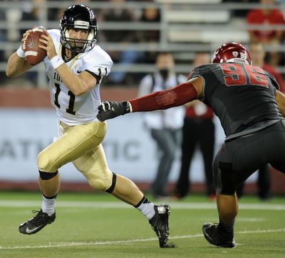 WSU defensive end Xavier Cooper grabs a handful of Idaho quarterback Chad Chalich during first-half action. (Tyler Tjomsland)
