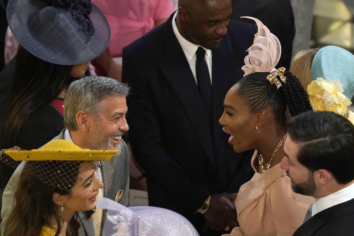George Clooney, center left, greets Serena Williams in St. George’s Chapel at Windsor Castle for the wedding of Prince Harry and Meghan Markle in Windsor, England on Saturday, May 19, 2018. In the foreground are Amal Clooney, left, and Alexis Ohanian. At background center is Idris Elba. (Owen Humphreys / Associated Press)