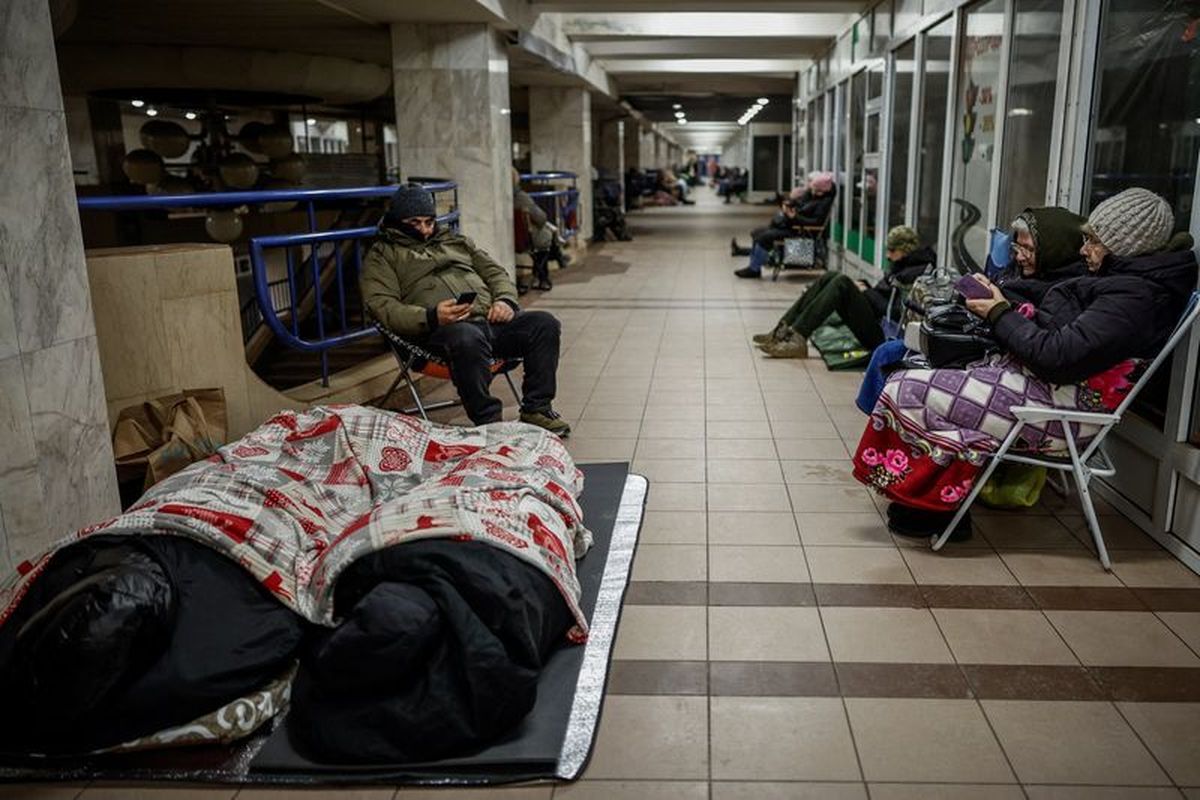 People take shelter inside a metro station during a Russian missile and drone strike, amid Russia