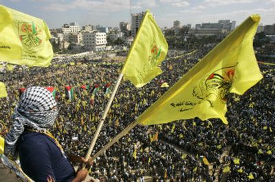 
A Fatah supporter waves  flags  at a rally  Monday in Gaza City that later turned violent. Associated Press
 (Associated Press / The Spokesman-Review)