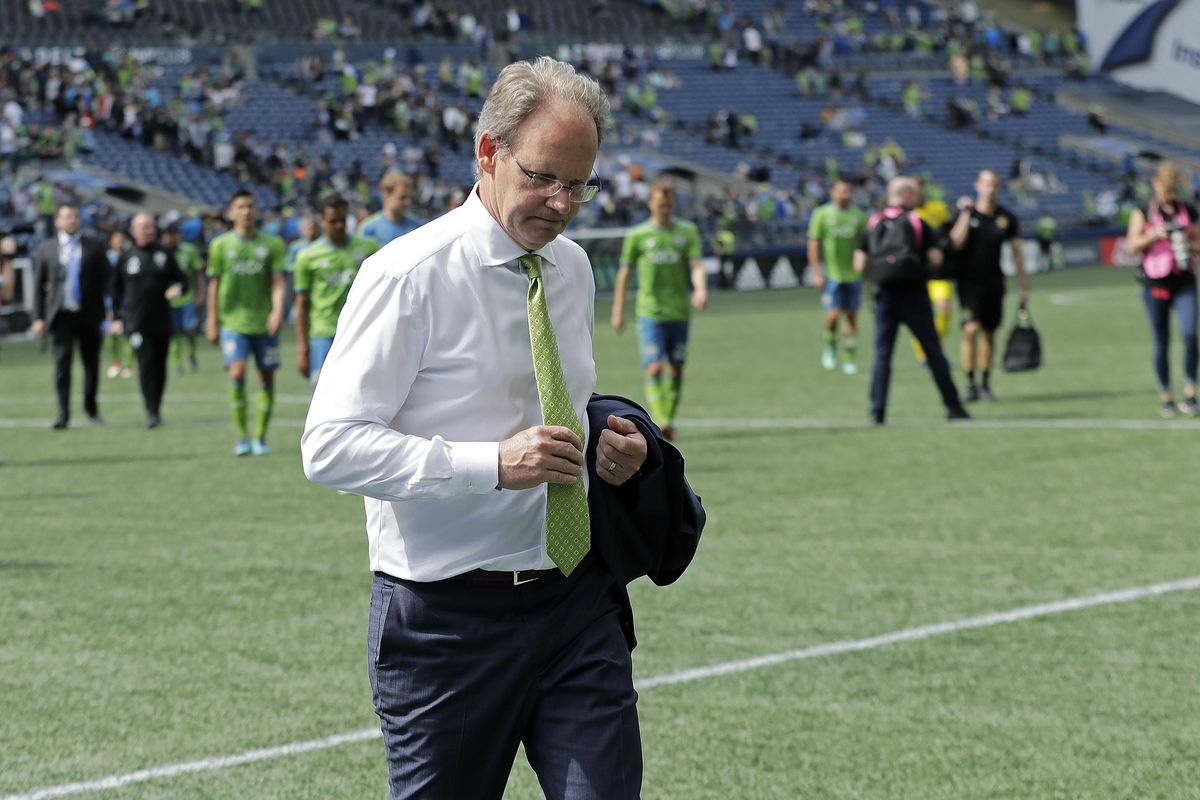 Seattle Sounders coach Brian Schmetzer holds his tie as he walks off the pitch following the team’s MLS soccer match against the Columbus Crew,  May 5 in Seattle. The match ended in a 0-0 draw. (Ted S. Warren / AP)