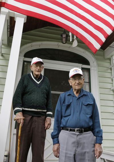 World War II veterans Bob Addison, left, and Gerald West pose for a photo Wednesday in Glens Falls, N.Y. (Associated Press)