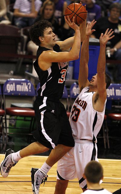 Priest River senior post Jake Weimer, who scored 28 points, shoots over Riley Sessions in the 3A State title game.  (Associated Press)