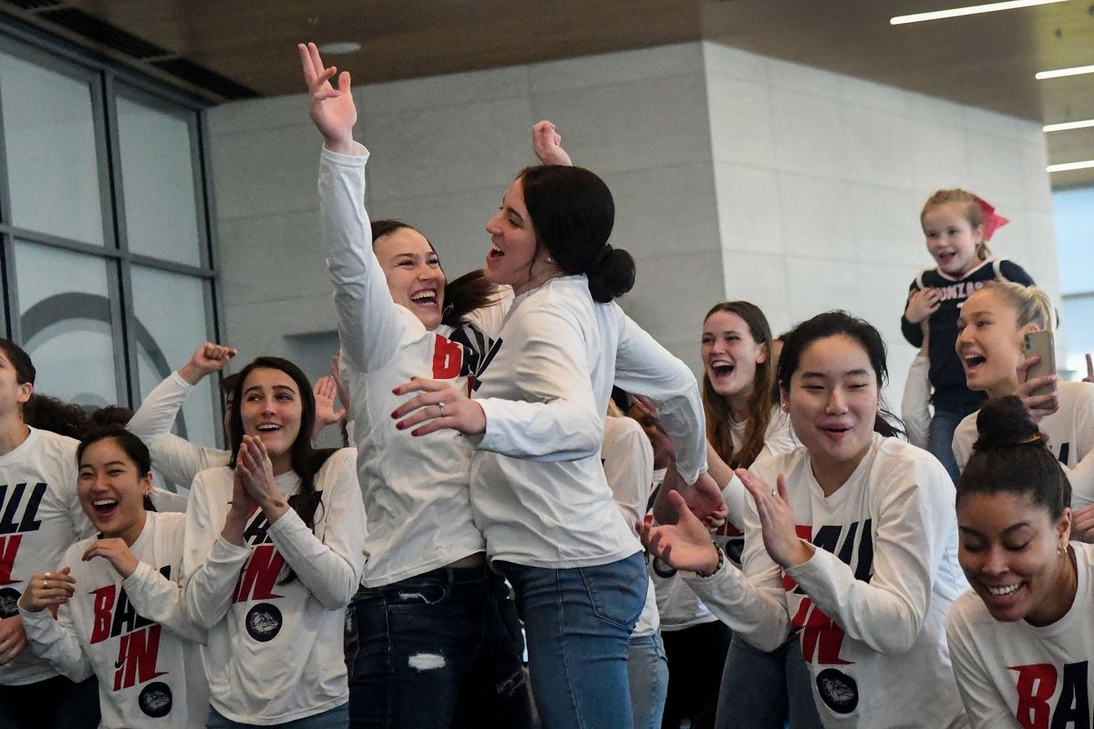 Gonzaga women’s basketball players Cierra Walker, center left, and Melody Kempton celebrate with their teammates at the McCarthey Athletic Center on Sunday.  (Kathy Plonka/The Spokesman-Review)