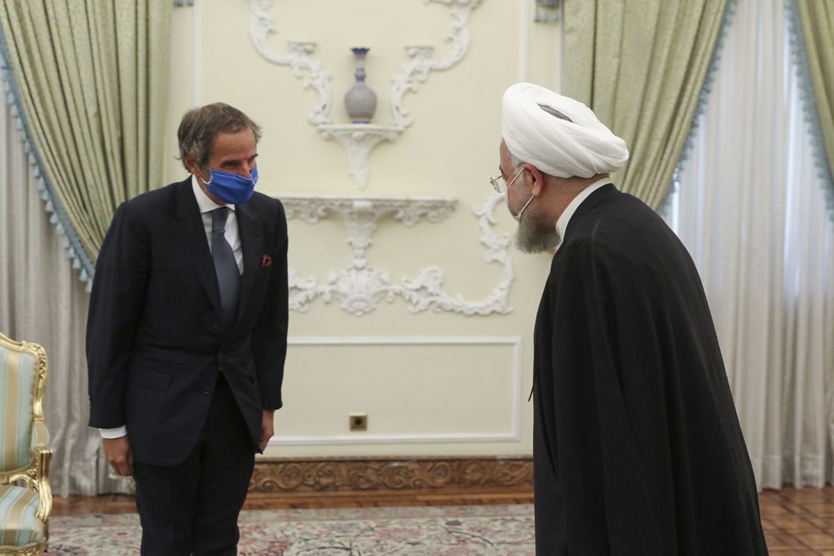 In this photo released by the official website of the office of the Iranian Presidency, President Hassan Rouhani, right, welcomes Director General of International Atomic Energy Agency, IAEA, Rafael Mariano Grossi for their meeting in Tehran, Iran, Wednesday, Aug. 26, 2020. The U.N. nuclear watchdog agency said Wednesday that Tehran has agreed to allow inspectors in to two sites where Iran is suspected of having stored or used undeclared nuclear material. (HOGP)