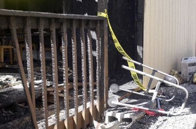 
A walker rests in debris Sunday afternoon after a fire scorched the Garden Homes assisted- living facility in Post Falls. 
 (Tom Davenport / The Spokesman-Review)