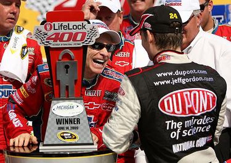 Mark Martin, driver of the No. 5 CARQUEST/Kellogg's Chevrolet, is congratulated in victory lane by teammate Jeff Gordon, driver of the No. 24 DuPont/National Guard 'Year of the NCO' Chevrolet, after Martin wins the NASCAR Sprint Cup Series LifeLock 400 at Michigan International Speedway on Sunday in Brooklyn, Mich. Gordon finished second. (Photo Credit: Ezra Shaw/Getty Images)  (Ezra Shaw / The Spokesman-Review)