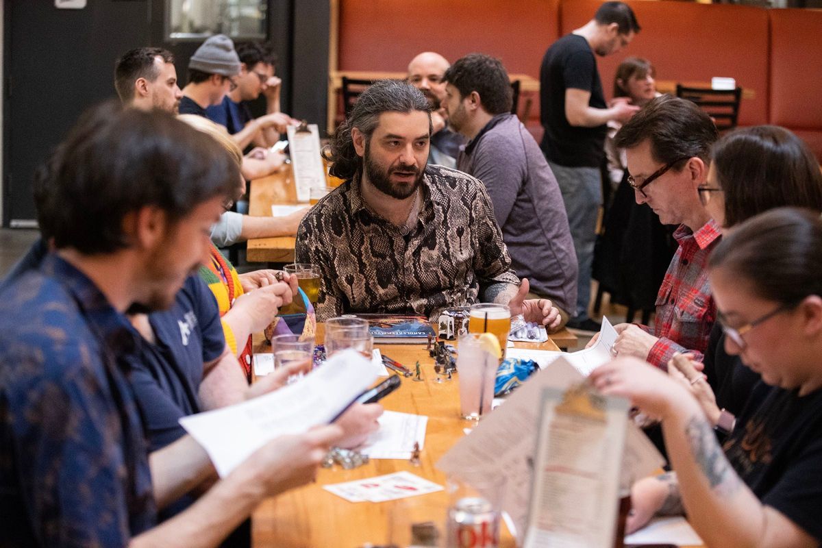 Alvaro Lopez-Moreno (center) leads a game of Dungeon & Dragons at Yards Brewing Company at 500 Spring Garden St. on March 27, 2024. Lopez-Moreno is one of 80 dungeon masters with Dungeons n Draft, a Philly-based organization that teaches people how to play Dungeons & Dragons at different bars.  (Charles Fox/The Philadelphia Inquirer/TNS)