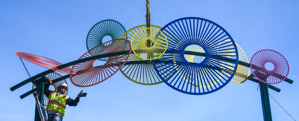 Daryl Sahli, of Cameron-Reilly Concrete, helps position an 18-foot art piece by Susan Zoccola, Monday, June 10, 2019, at the West End Plaza in downtown Spokane. (Dan Pelle / The Spokesman-Review)