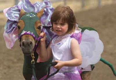 
A 3-year-old girl leads a miniature horse at a show in Pasco, Wash. Miniature horses are gaining popularity as pets and as working animals.
 (File/Associated Press / The Spokesman-Review)