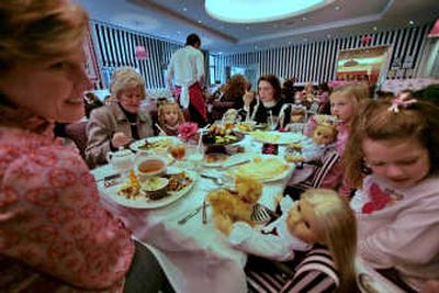 
Suzane Sanders, far left, and her daughter, Hailey Sanders, 7, far right, join Beth Nucholls, third from right, with her daughters Avery, 5, third from left, and Day Nucholls, 7, second from right, and her mother Janis Turrentine, second from left, as the families from Greenville, S.C., share a meal with dolls at the American Girl Place restaurant in New York.Associated Press
 (Associated Press / The Spokesman-Review)