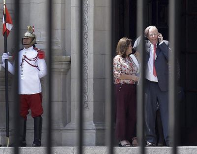 Peru's President Pedro Pablo Kuczynski talks on his cellphone as he leaves the Government Palace also known as the House of Pizarro, in Lima, Peru, Wednesday, March 21, 2018. (Martin Mejia / Associated Press)