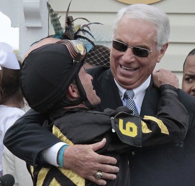 Jockey Gary Stevens, left, and trainer D. Wayne Lukas celebrate in the winner’s circle after Oxbow won Saturday’s Preakness Stakes. (Associated Press)