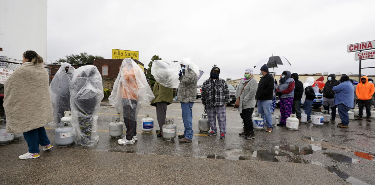 People wait in line to fill propane tanks Wednesday, Feb. 17, 2021, in Houston. Customers had to wait over an hour in the freezing rain to fill their tanks. Millions in Texas still had no power after a historic snowfall and single-digit temperatures created a surge of demand for electricity to warm up homes unaccustomed to such extreme lows, buckling the state