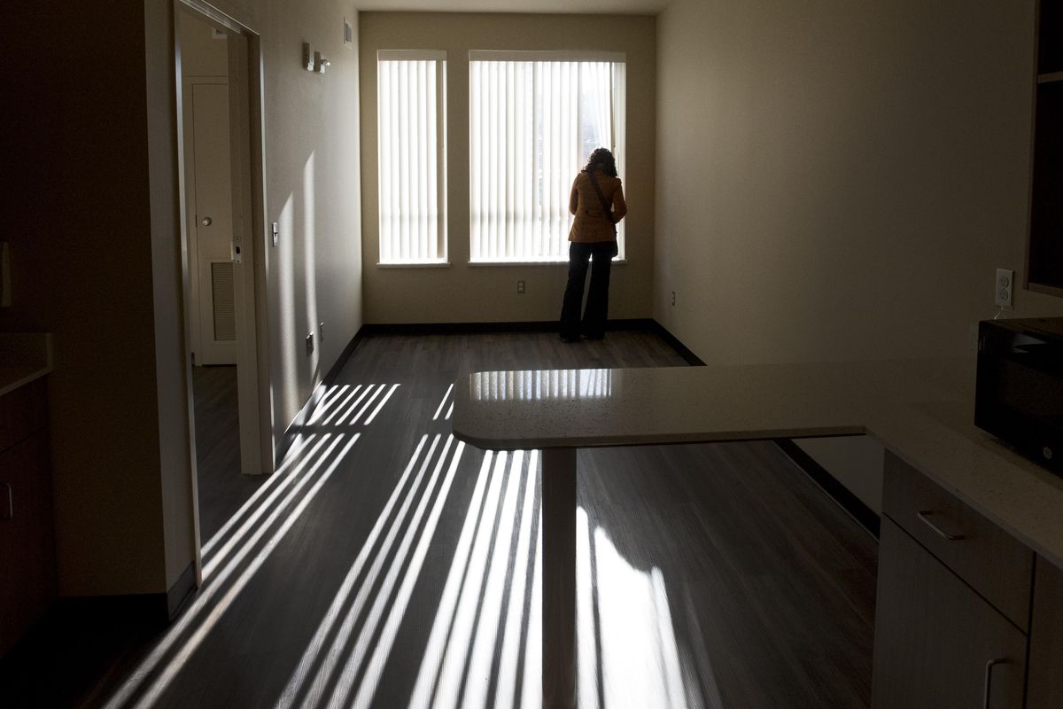 Brianne Howe, a community court coordinator, checks out one of the rooms in the new Donna Hanson Haven community housing project on Friday, Nov. 17, 2017, in Spokane, Wash. (Tyler Tjomsland / The Spokesman-Review)