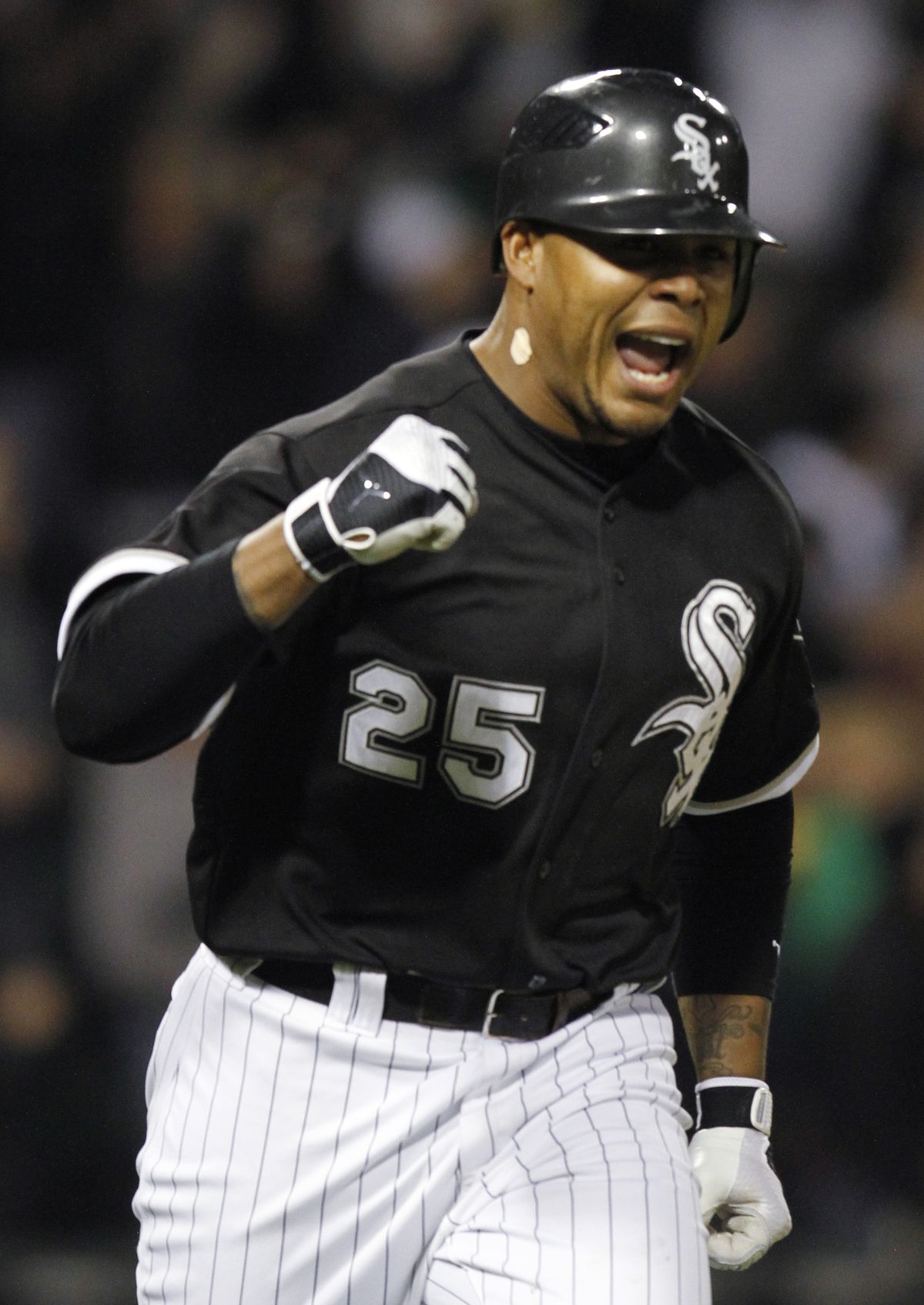 Andruw Jones celebrates as he rounds the bases after his game-winning solo home run for Chicago.  (Associated Press)
