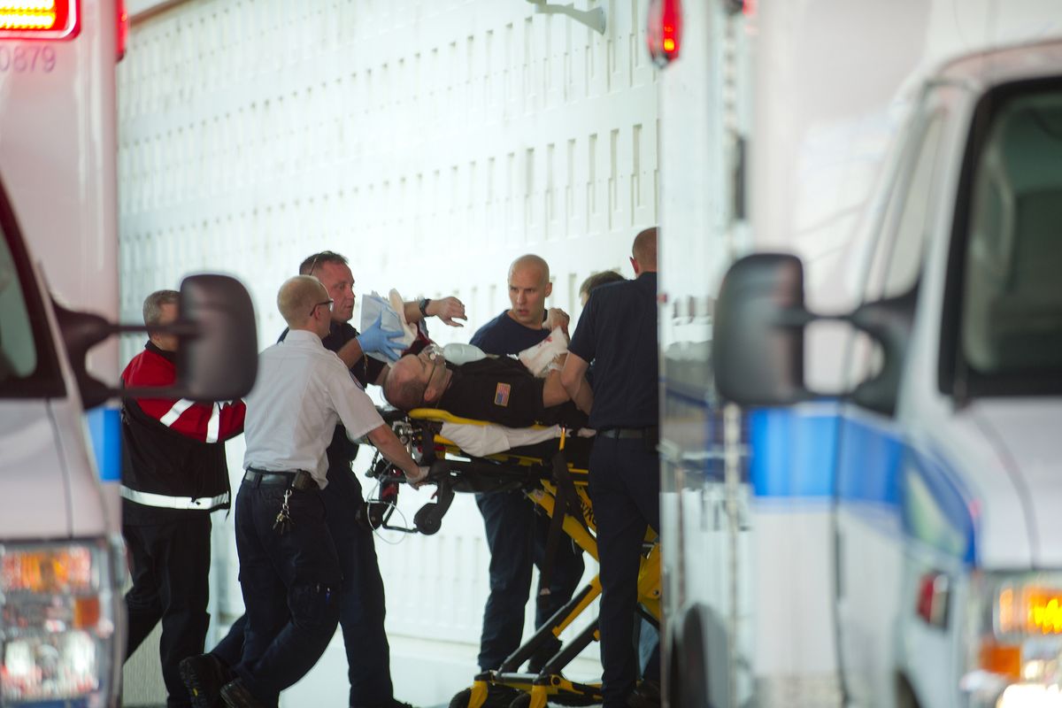 One of two wounded deputies is rolled into the emergency room at Providence Sacred Heart Medical Center on Tuesday in Spokane. (Tyler Tjomsland)