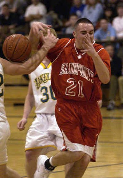 
Sandpoint's Chris Hepperly has his arm separated from the ball by a Lakeland defender. 
 (Tom Davenport/ / The Spokesman-Review)