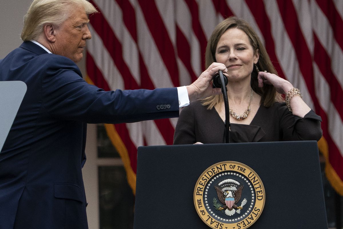 President Donald Trump adjusts the microphone after he announced Judge Amy Coney Barrett as his nominee to the Supreme Court, in the Rose Garden at the White House, Saturday, Sept. 26, 2020, in Washington.  (Associated Press)