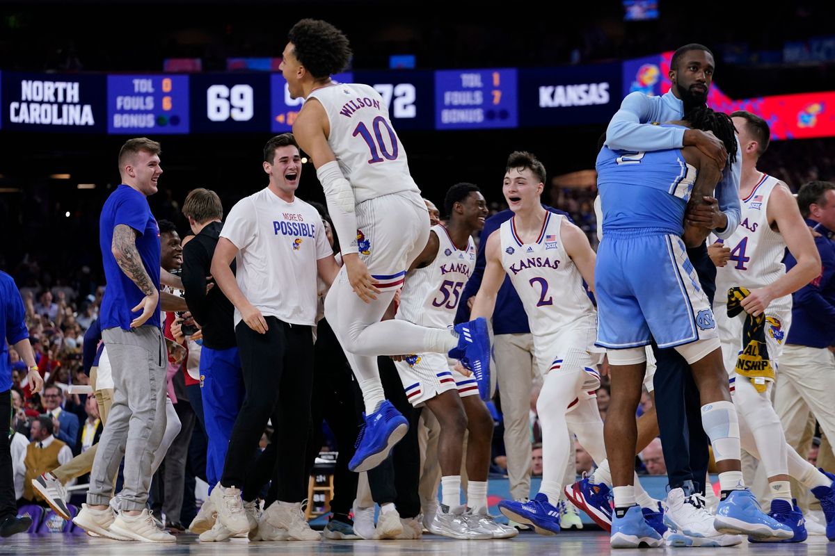 North Carolina guard Caleb Love, right, reacts to a loss as Kansas