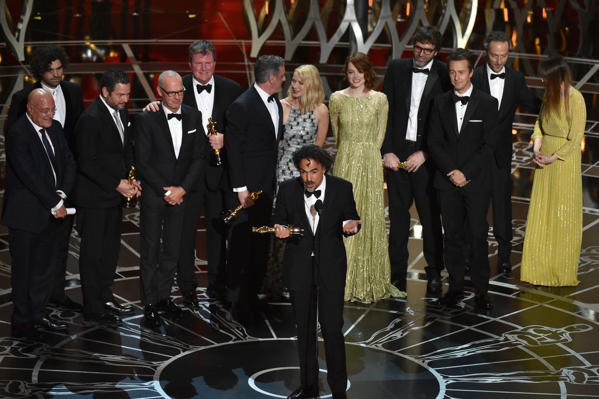 Alejandro G. Inarritu, center, and the cast and crew of “Birdman or (The Unexpected Virtue of Ignorance)” accept the award for the best picture at the Oscars on Sunday at the Dolby Theatre in Los Angeles. (Associated Press)