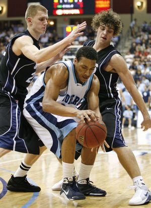 Gonzaga's Micah Downs, left, and Matt Bouldin, right, double-team San Diego's De'Jon Jackson. (Denis Poroy / Associated Press)