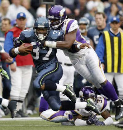 Seattle's Shaun Alexander tries to shake Minnesota's E.J. Henderson during the second quarter of Saturday's game.Associated Press
(Associated Press / The Spokesman-Review)