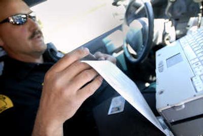 
WSP Trooper Nick Gerad prints a ticket from his patrol car along Interstate 90 in Spokane. New technology in vehicles allows quicker ticket processing. 
 (Photos by Brian Plonka / The Spokesman-Review)