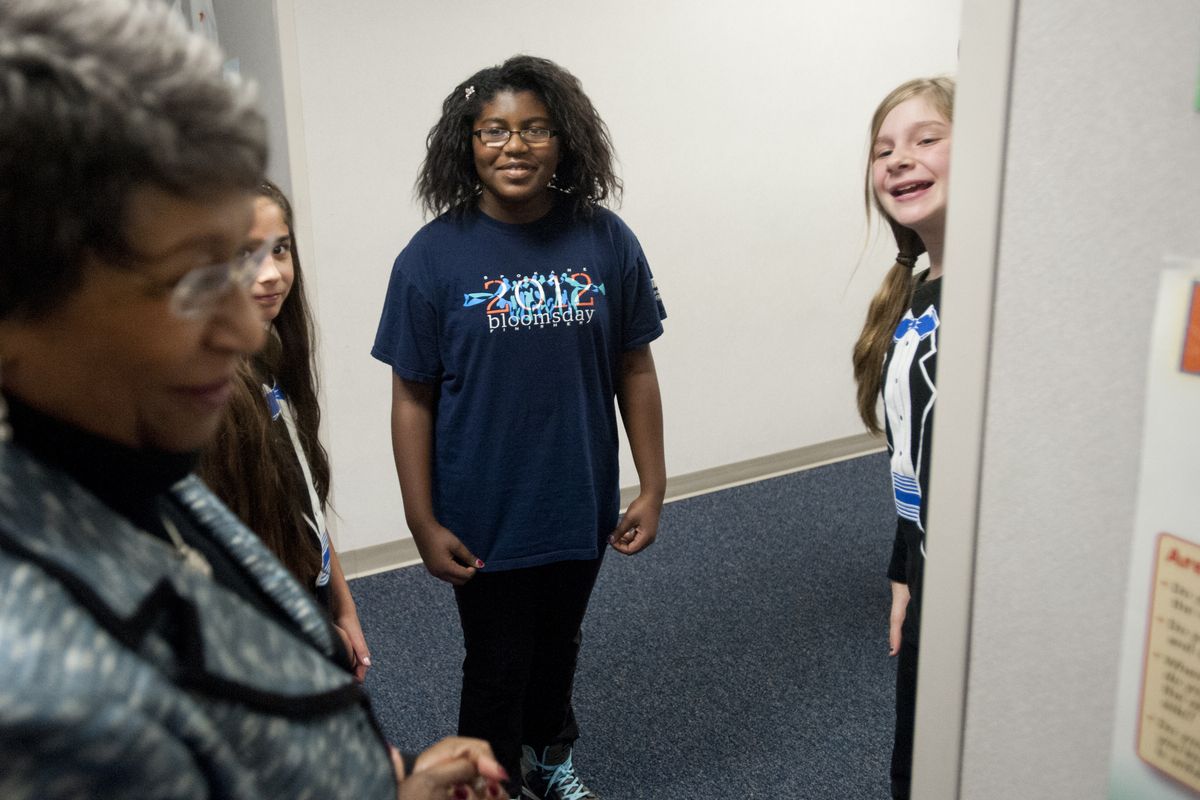 Barbara Anderson, foreground, the mother of the late Lt. Col. Michael P. Anderson, an astronaut who died in the Space Shuttle Columbia crash in 2003, smiles as she checks out hallway decorations honoring her son as fifth-graders Asia Psota, left, Ariana Love, center, and Margaret Jacquay wait to meet her on Thursday at Michael Anderson Elementary on Fairchild Air Force Base. (Tyler Tjomsland)
