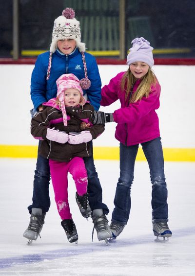A little shaky on her skates, Brynn Baker, 4, is helped by her sisters Kara, 12, left, and Asia, 9, Tuesday at the Riverfront Park Ice Palace. With the recent voter approval for the renovation of Riverfront Park, one plan is to build a new open-air ice rink along Spokane Falls Boulevard across from Spokane City Hall. (Colin Mulvany)
