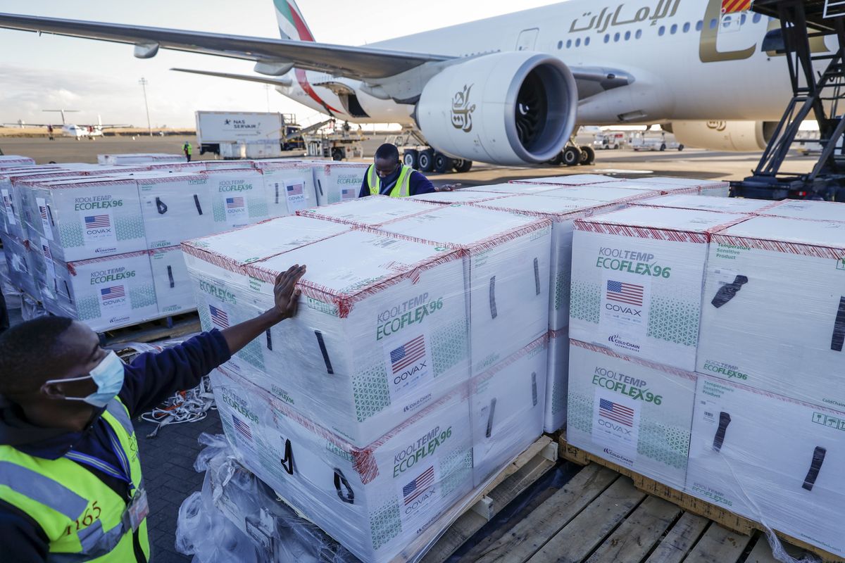 FILE - In this Monday, Aug. 23, 2021 file photo, an airport worker stands next to boxes of Moderna coronavirus vaccine, donated by the U.S. government via the COVAX facility, after their arrival at the airport in Nairobi, Kenya. Moderna said Tuesday, Oct 26, 2021 that it will make up to 110 million doses of its COVID-19 vaccine available to African countries with the first 15 million doses delivered by the end of this year, 35 million in the first quarter of 2022, and up to 60 million in the second quarter of 2022.  (Brian Inganga)