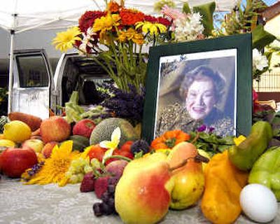 
A makeshift memorial for French chef Julia Child is shown at the Santa Barbara Saturday Farmers' Market one day after her death. Visitors left food and floral items on a table with her photo. 
 (Associated Press / The Spokesman-Review)