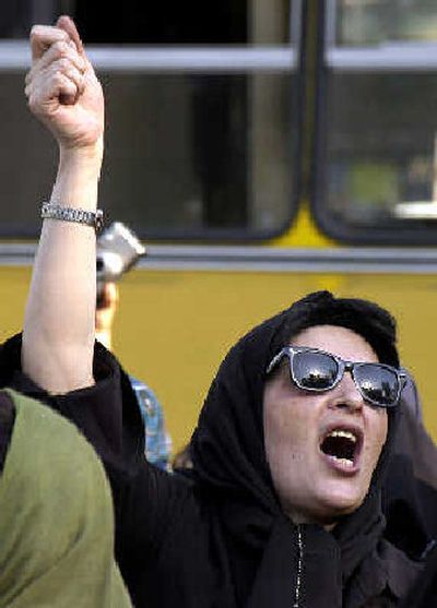 
A woman shouts women's rights slogans at an Iranian Women Movement rally in front of Tehran University on Sunday. About 300 women protested gender discrimination in the Islamic Republic. 
 (Associated Press / The Spokesman-Review)