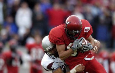 
Eastern's Craig McIntyre clutches the ball while his opponent from the University of Montana attempts to tackle him during a home game in October.
 (File/ / The Spokesman-Review)