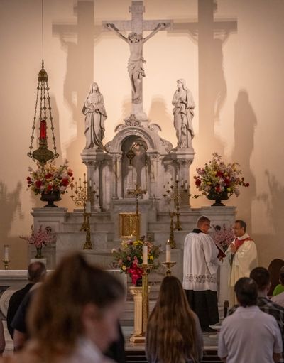 With new Pope Leo XIV announced to lead the Catholic Church, a noon Mass is performed by Father Kyle Ratuiste, right, with alter server Justin Bullock at the Cathedral of Our Lady of Lourdes on Thursday in downtown Spokane. (Colin Mulvany/The Spokesman-Review)