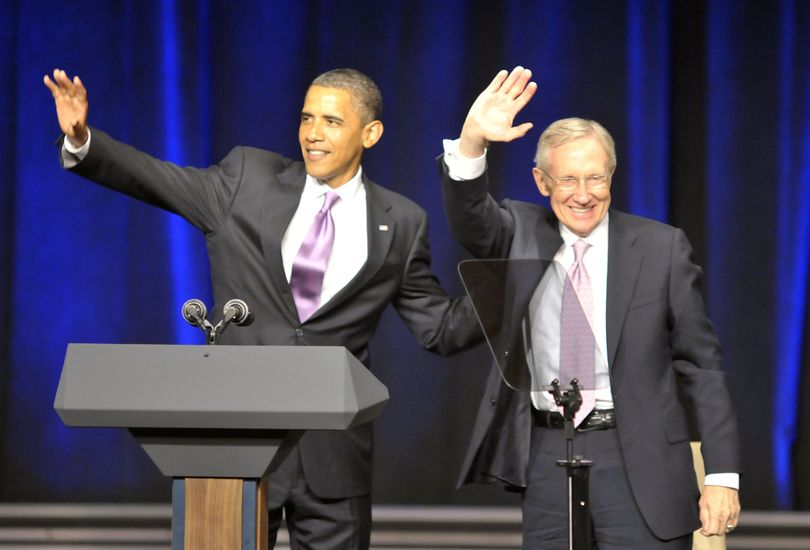 President Barack Obama, left, waves to the crowd with Sen. Harry Reid, D-Nev., right, at a Reid campaign rally at the Aria Resort at CityCenter Las Vegas on July 8, 2010. (Mark Damon / Fr170373 Ap)