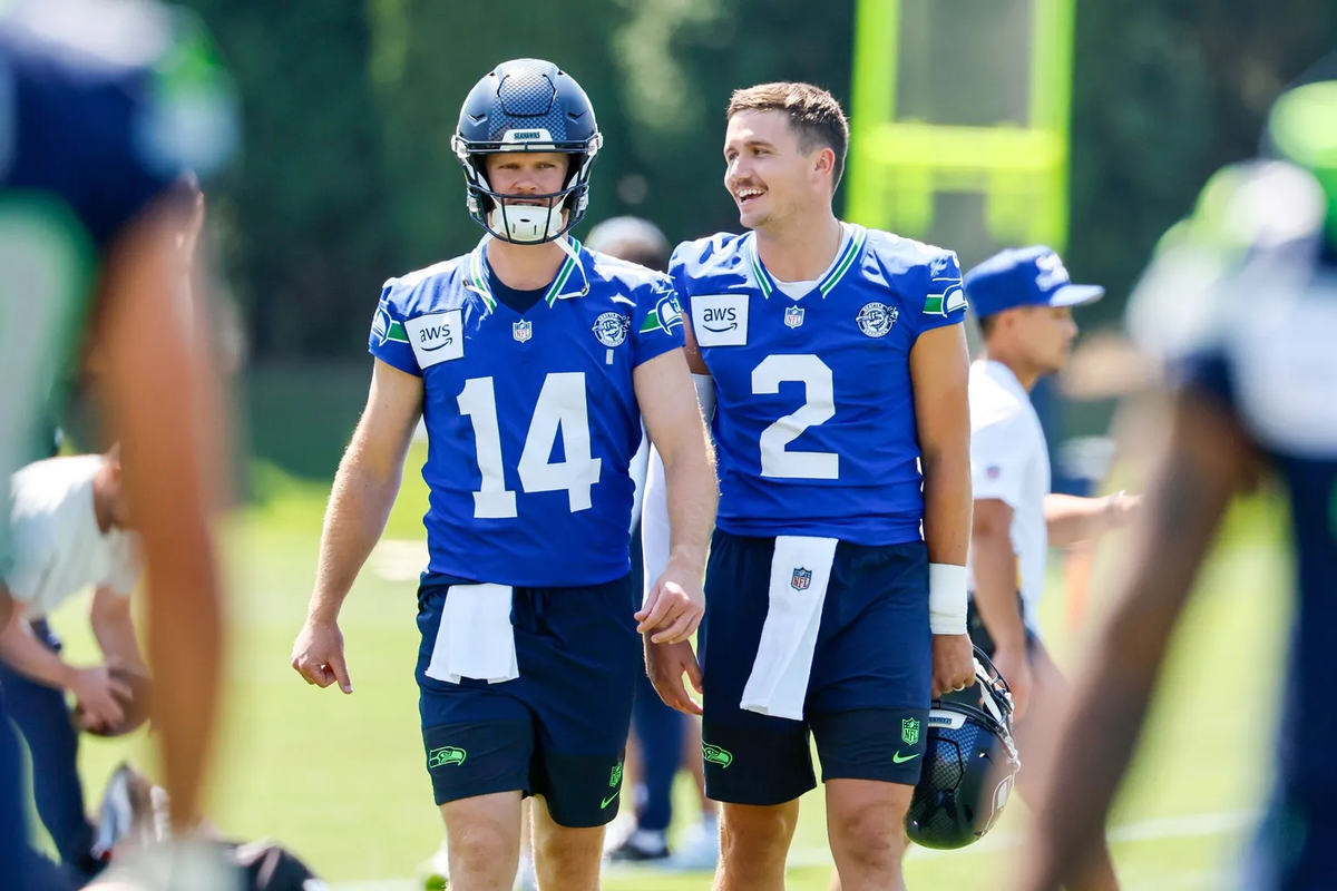 Seahawks quarterbacks Sam Darnold, left, and Drew Lock chat during the first day of training camp on Wednesday in Renton, Wash. (Jennifer Buchanan/Seattle Times)