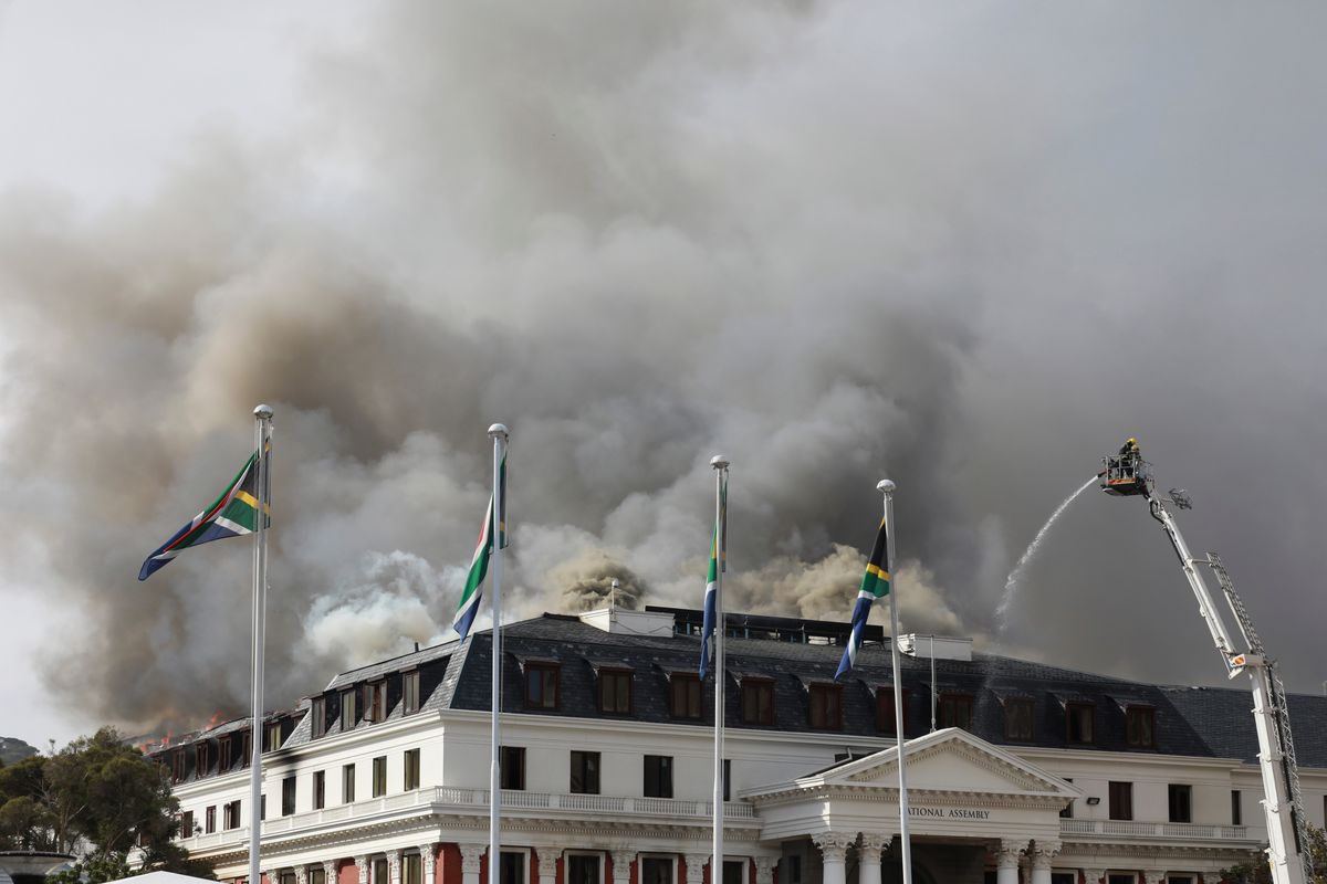 Smoke rises from the Parliament in Cape Town, South Africa, on Monday after the fire re-ignited late afternoon. Firefighters are again on the scene after a major blaze tore through the precinct a day earlier.  (Nardus Engelbrecht)