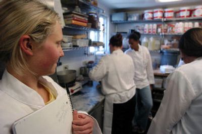 Eli Penberthy, left, watches as a group of local high school students try their luck in the kitchen of Luna Restaurant last year.
(Christopher Anderson / The Spokesman-Review)