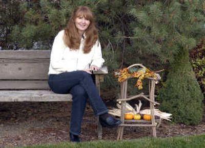 
Tammy Richert sits in her Spokane Valley backyard with an end table she designed and built out of twigs and branches that she gathered. Her dad built the bench she's sitting on out of lumber that they found on beaches at Lake Coeur d'Alene.
 (Photos by J. BART RAYNIAK / The Spokesman-Review)