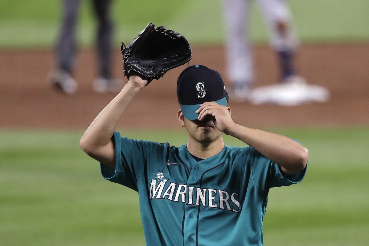 Mariners starting pitcher Yusei Kikuchi adjusts his cap during Seattle’s 8-4 home loss to Colorado on Friday night.  (Associated Press)