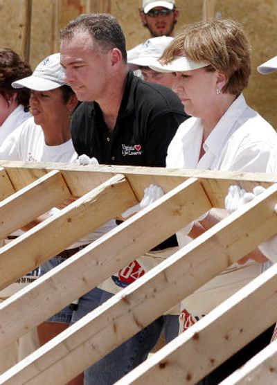 
Louisiana Gov. Kathleen Blanco, right, and Virginia Gov. Timothy M. Kaine help raise a wall Saturday at the Habitat for Humanity Musicians' Village in New Orleans.
 (Associated Press / The Spokesman-Review)