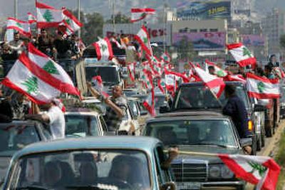 
Lebanese opposition demonstrators wave national flags in central Beirut on Monday as hundreds of thousands  answered a call for a massive anti-Syria protest. 
 (Associated Press photos / The Spokesman-Review)