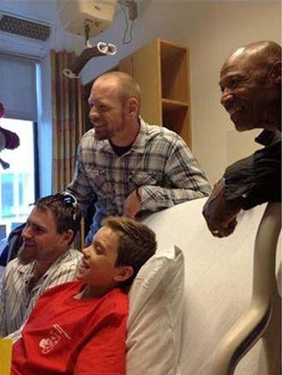 Oakland’s Josh Reddick, left, Brandon Moss, top center, and Tye Waller, right, visit Aaron Hern in the hospital. (Associated Press)